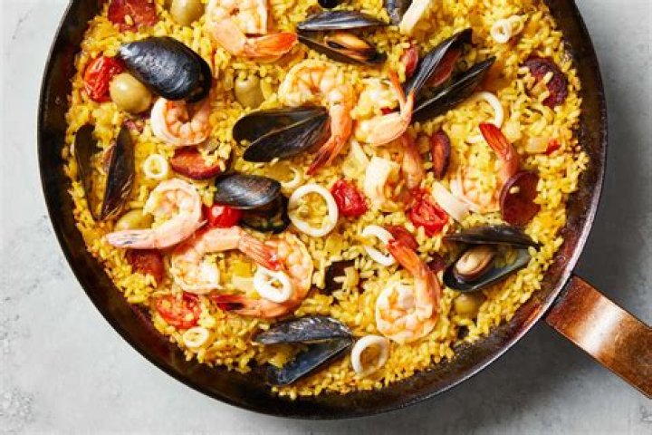 How is paella traditionally made?
